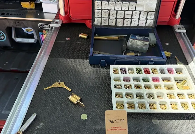 Locksmith rekeying work with key pins and cylinders in a service workspace.