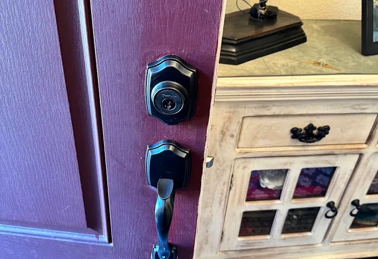 Deadbolt and lever on a residential front door.